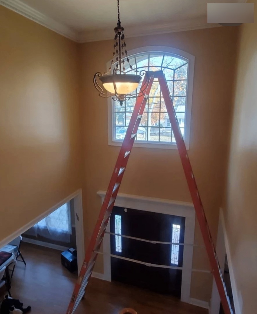 Two-story foyer painting and light install — before