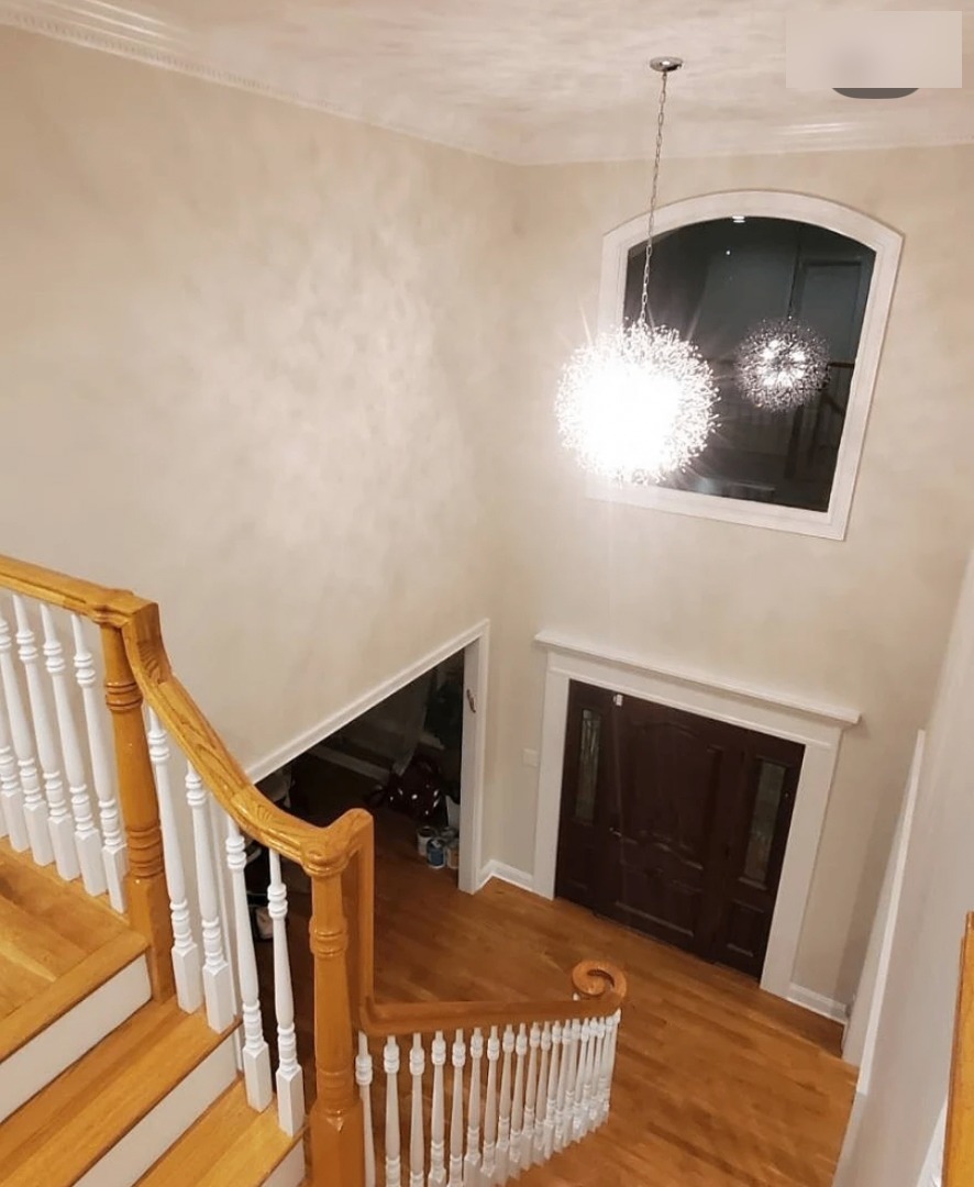 Two-story foyer with new chandelier — after